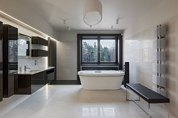 Luxury bathroom interior Interior of modern luxury minimalistic bathroom with window free standing bath photos stock pictures, royalty-free photos & images