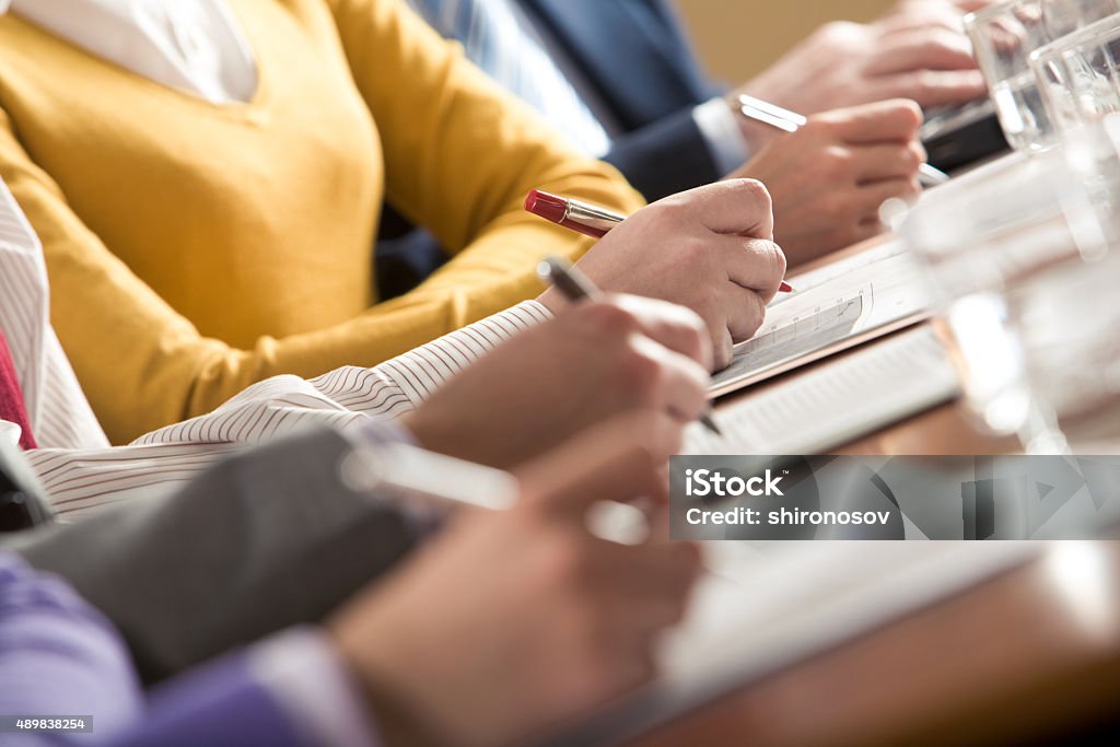 Writing summary Close-up of peoples hands making written review of planned work    Note to inspector: the image is pre-Sept 1 2009 2015 Stock Photo