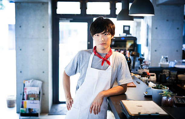 Handsome Asian Cook Leaning on a Bar Counter