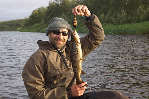 istock Fisherman caught a nice brown trout. 489839696