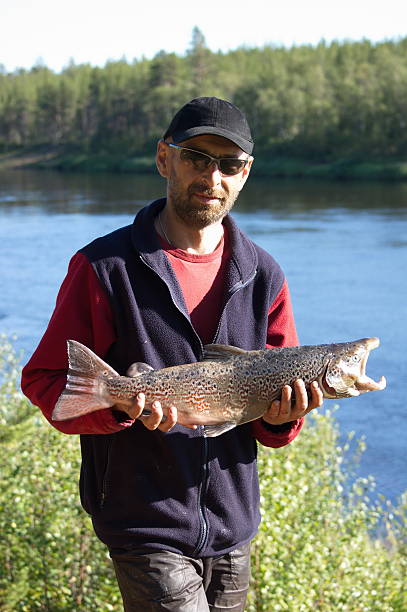istock Fisherman caught a nice male salmon. 489841238