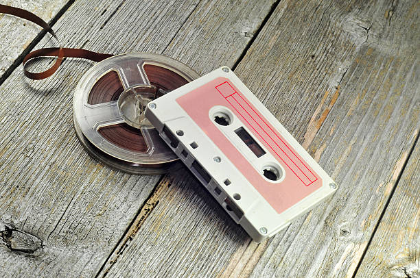 Old cassete and tape Photo of old music cassette and tape reel to reel tape stock pictures, royalty-free photos & images