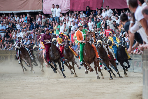 Siena, Italy - August 16, 2015: Riders compete in the famous horse race 