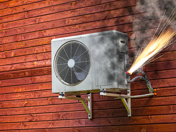 Air conditioner on fire Overloaded electrical circuit causing electrical short and fire. breaking stock pictures, royalty-free photos & images