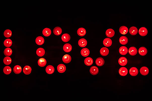 istock Word love written with candles on a dark background 489862972