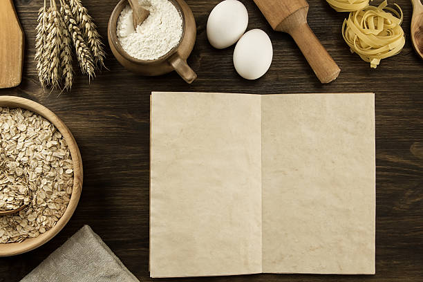 istock open old vintage book on the aged wooden background. 489865082