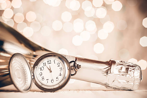 istock New Year's clock and champagne at midnight 489865422