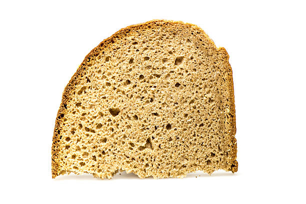 スライスの背景に白のパンと影 - graubrot ストックフォトと画像