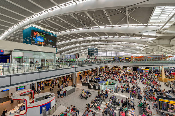 London Heahtrow Airport Terminal 5 departures London, England - September 1, 2015: Heathrow Terminal 5 is an airport terminal at Heathrow Airport serving the UK city of London. Opened in 2008, the main building in the complex is the largest free-standing structure in the United airport terminal stock pictures, royalty-free photos & images