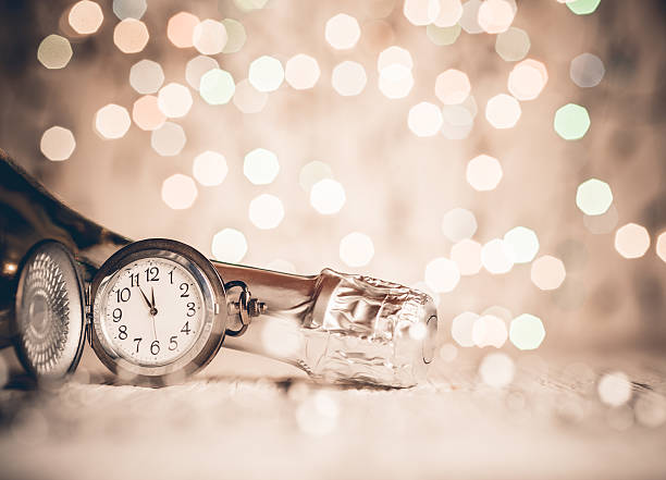 istock New Year's clock and champagne at midnight 489866064