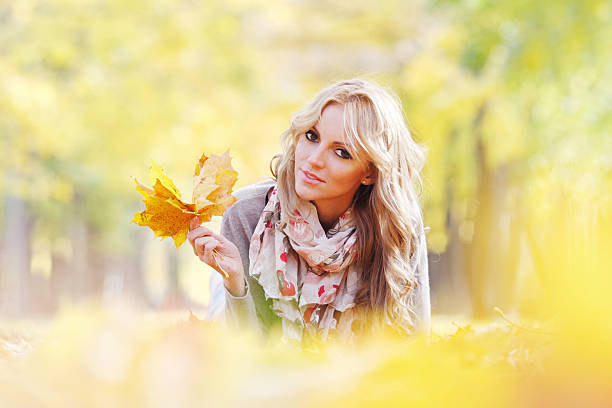 istock Woman lying in autumn leaves 489866684
