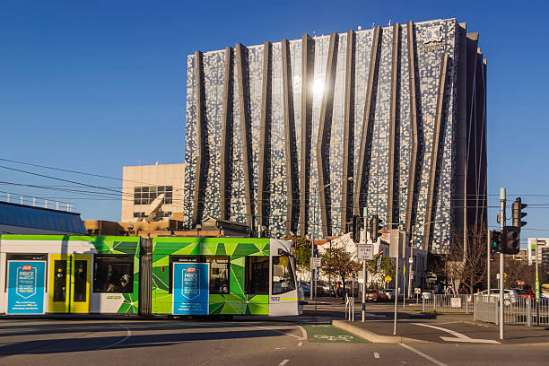 Melbourne, Australia - August 20, 2015: A tram passes the The Spot, which houses the University of Melbourne's business school.