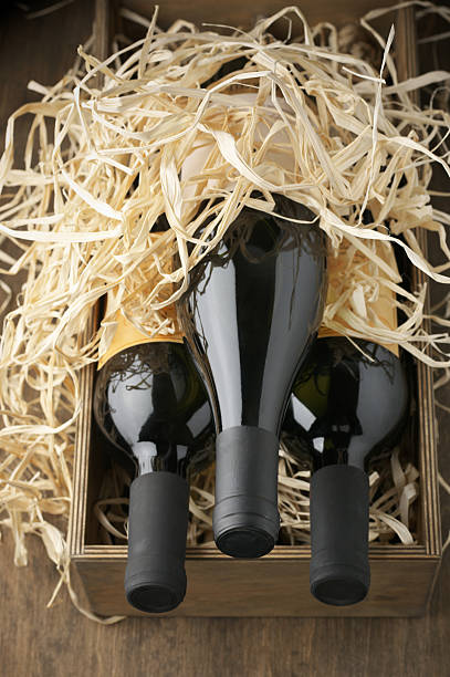 istock Wine bottles in wooden box and straw 489869076