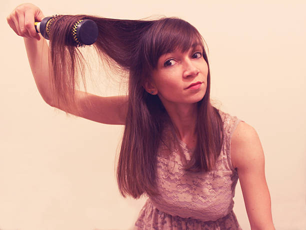 istock Girl with hair brush 489870234