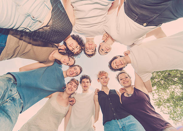 istock Group of friends in a huddle looking down at camera 489870460