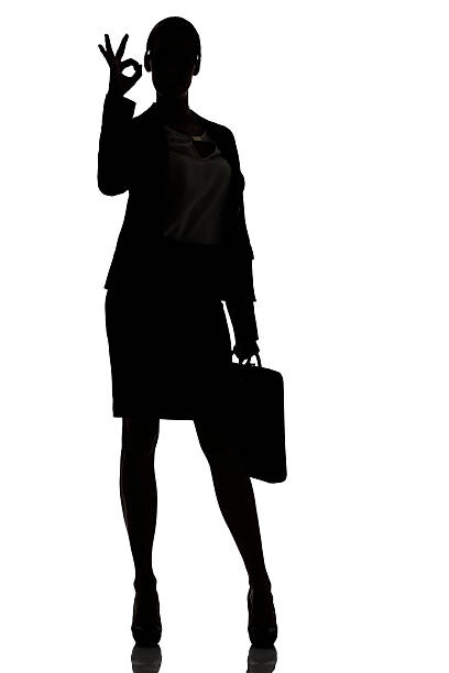 istock silhouette of a busy business woman backlight studio 489870708
