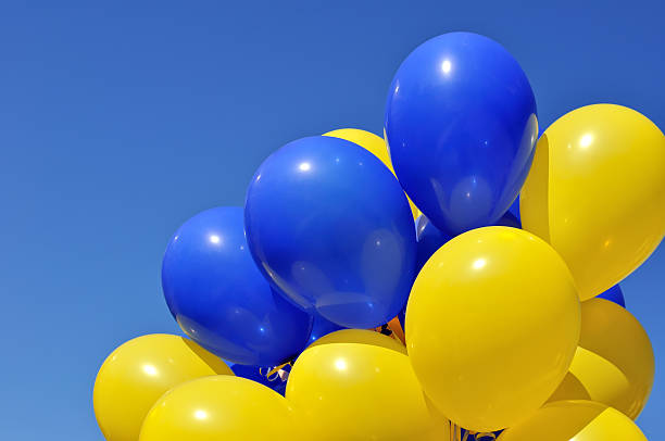 blue and yellow balloons in the city festival stock photo