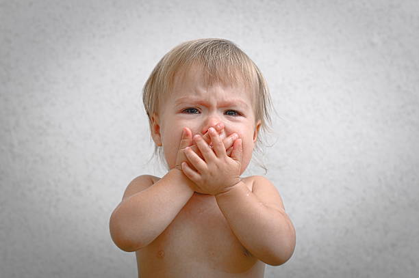 Asian Little girl crying indoors