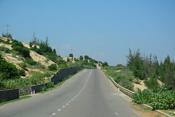 istock Mountain road at sunny day with clouds 489872512