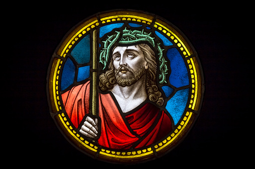 Colourful medieval stained glass window depicting Jesus Christ in crown of thorns made by an unknown author