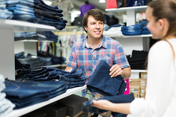 istock couple chooses jeans at the shop 489897452