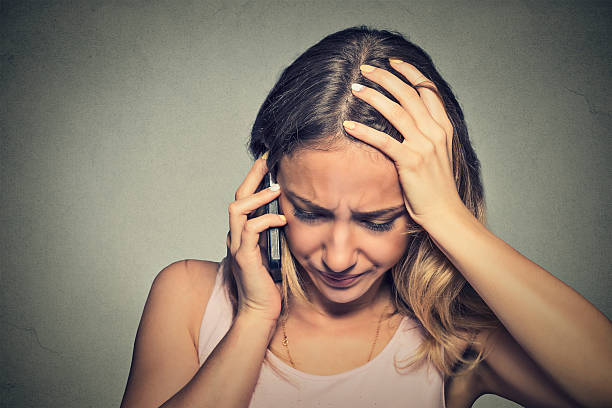 istock young woman talking on mobile phone looking down 489901794