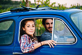 Loving couple in a blue vintage car
