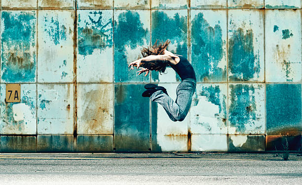 istock Woman makes a difficult jump through the air 489903756