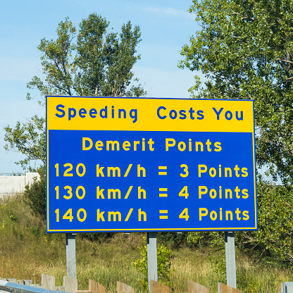 Ontario, Canada - August 29, 2014: A sign in Ontario warning of the Demerit Point fine if you are caught speeding.