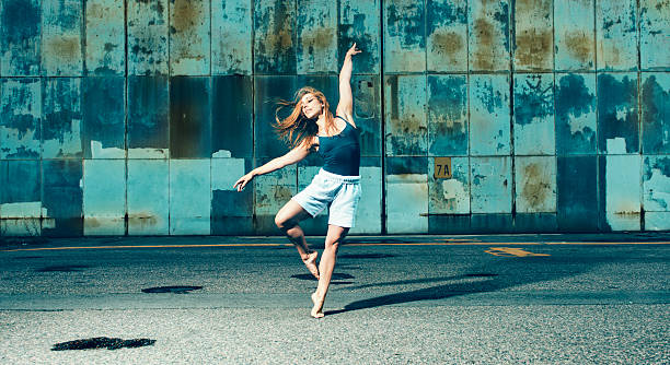 istock Female dancer with bare feet on concrete 489903950