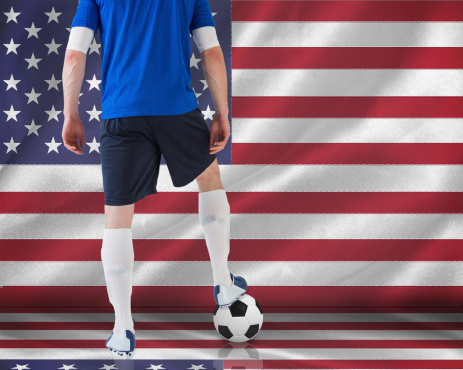 Football player in blue jersey against digitally generated american national flag