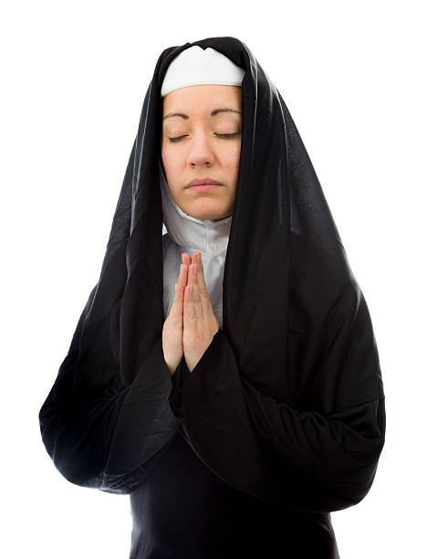istock Young nun in prayer position 489905485