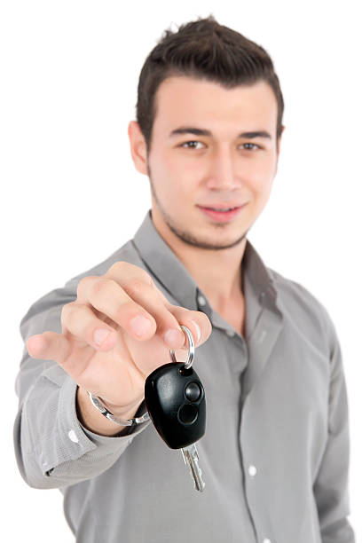 istock young man gives car key 489905891
