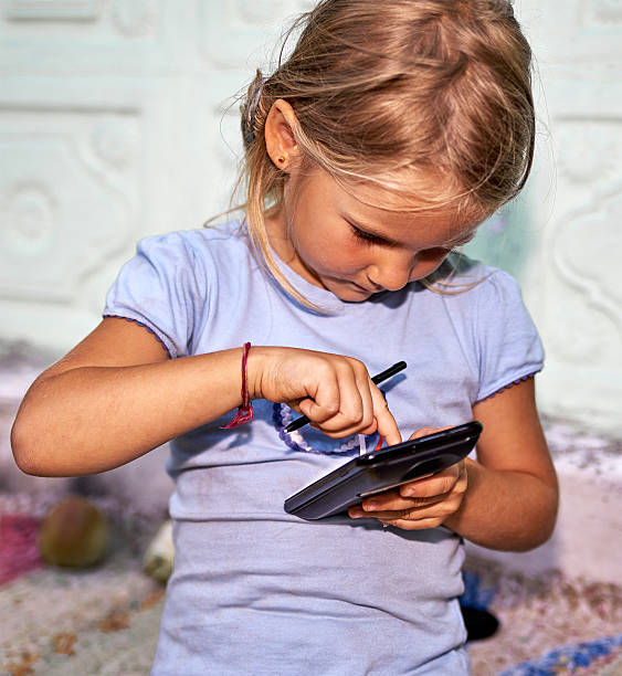 istock Little girl with smartphone 489906372