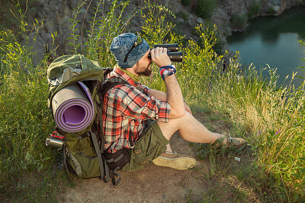istock Young caucasian man with backpack sitting on the top of 489906880