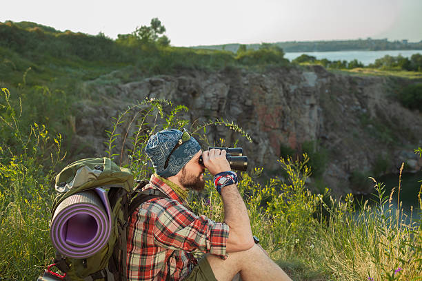 istock Young caucasian man with backpack sitting on the top of 489906882