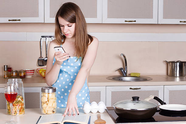 istock Girl in a blue apron the kitchen 489907602