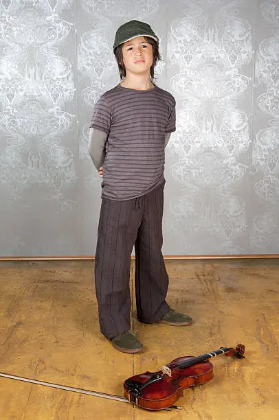 Photo of boy wearing a hat with violin