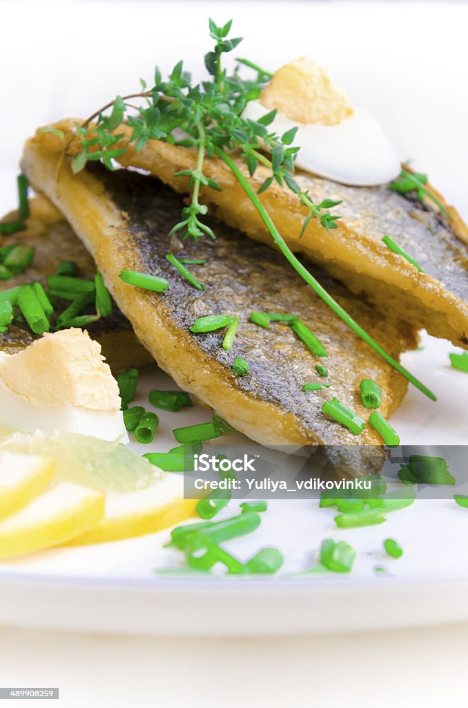 Fried Dorada Fillet with egg, chives and thyme Backgrounds Stock Photo