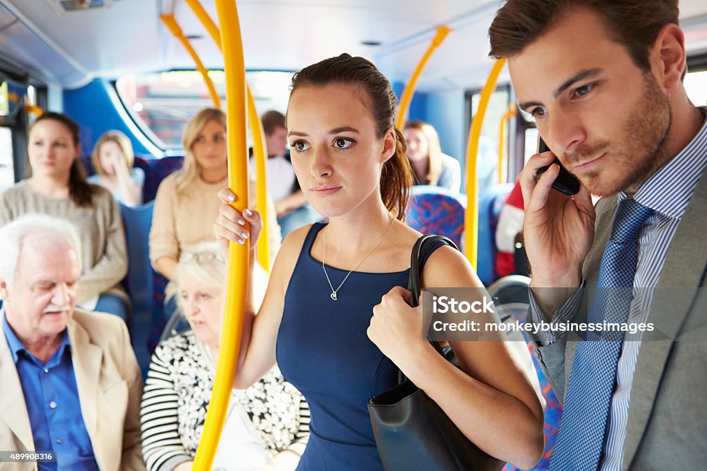 Passengers Standing On Busy Commuter Bus Passengers Standing On Busy Commuter Bus To Work Bus Stock Photo