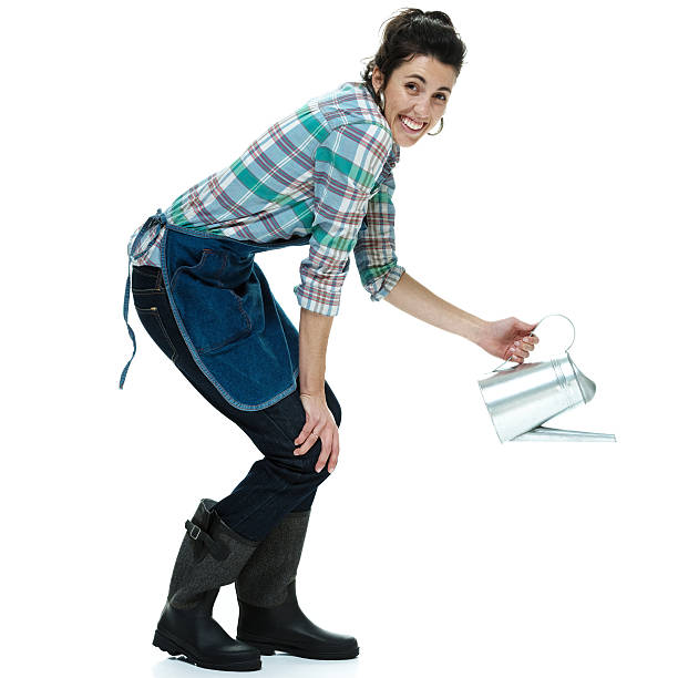 istock Cheerful farmer in action with watering can 489908413