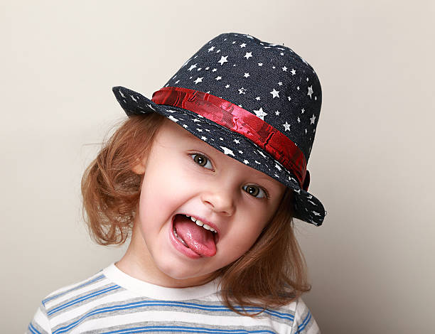 istock Happy grimacing kid in hat showing the tongue 489908625