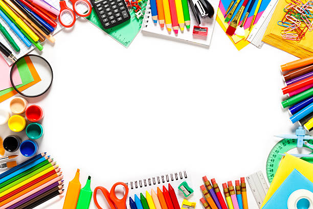 School supplies border against white background. The composition includes books, note pad, paper clips, color pencils, note pad, loupe, paintbrushes, watercolors, crayons, eraser, pencil sharpener, scissors, compass, ruler, calculator and pushpins. Useful copy space left at the center of the frame. High angle view DSRL studio photo taken with Canon EOS 5D Mk II and Canon EF 100mm f/2.8L Macro IS USM