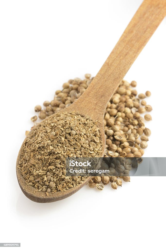 coriander powder and spoon coriander powder and spoon isolated on white background Coriander Seed Stock Photo