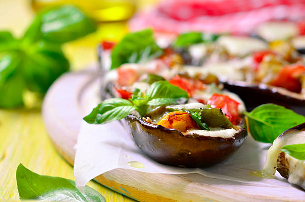 istock Baked eggplants stuffed with vegetable and mozzarella. 489909796