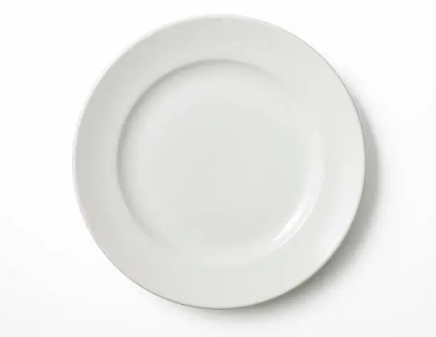 Overhead shot of empty white plate isolated on white background with clipping path.