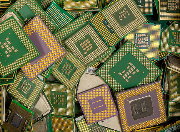 Computer CPUs For Recycling An assorted pile of obsolete computer CPUs for recycling. The CPUs have gold plated pins. e waste photos stock pictures, royalty-free photos & images