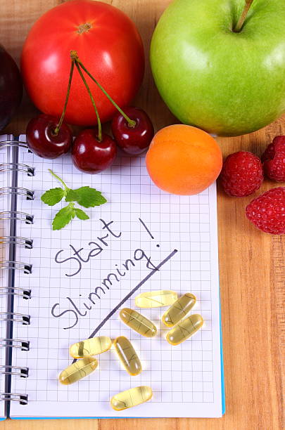 istock Fruits and tablets supplements with notebook, slimming and healthy food 489926106