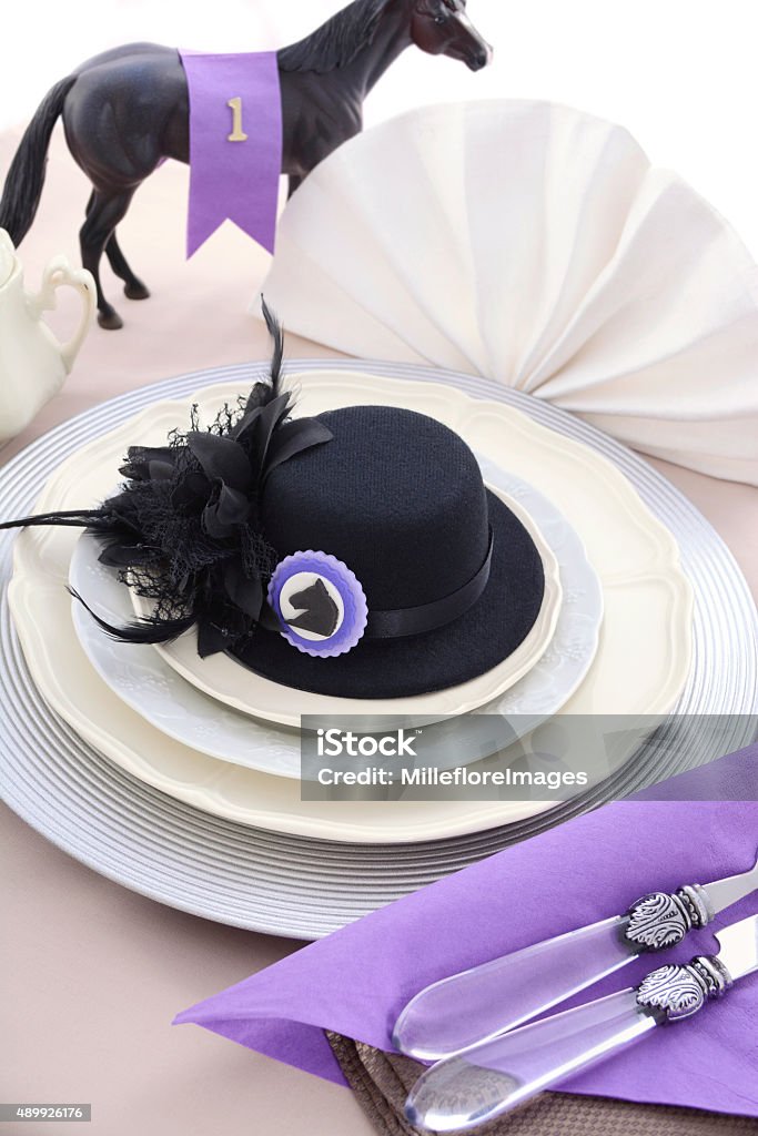 Horse Race Day Ladies Luncheon table setting. Horse racing Ladies Luncheon fine dining table setting with small black fascinator hat, decorations and champagne. Hat Stock Photo