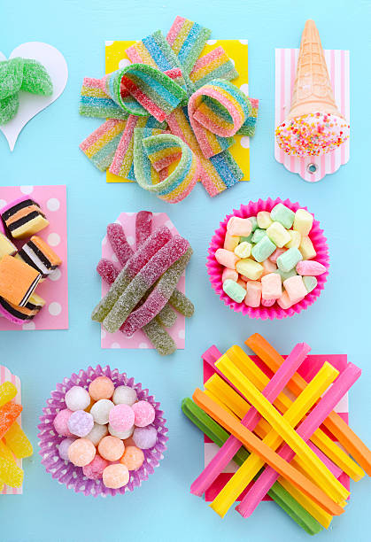istock Bright Colorful Candy on Pale Bluw Wood Table. 489926638